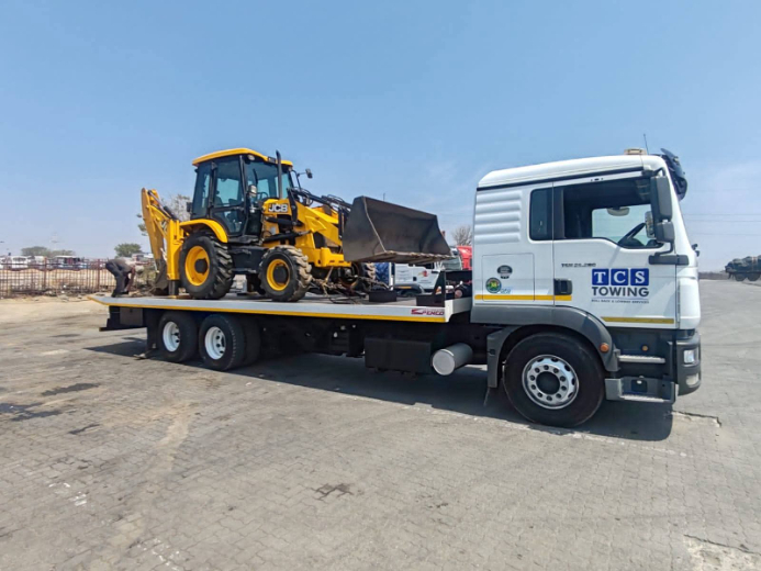 JCB backhoe transported on MAN rollback nationwide